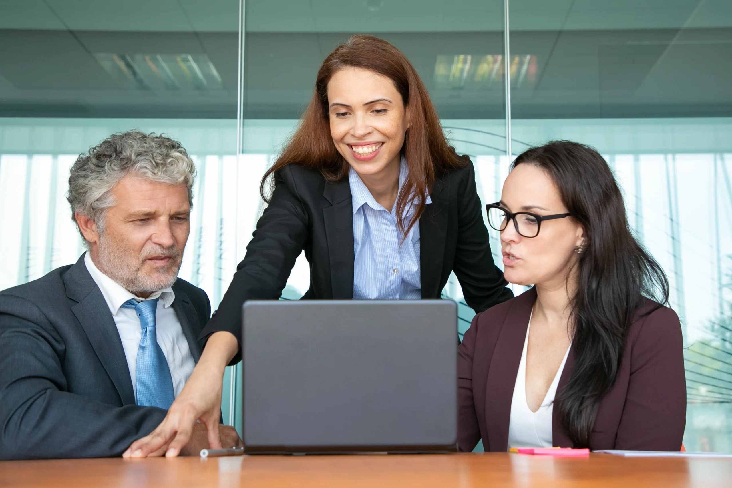 cheerful confident manager sharing ideas with colleagues showing presentation computer scaled